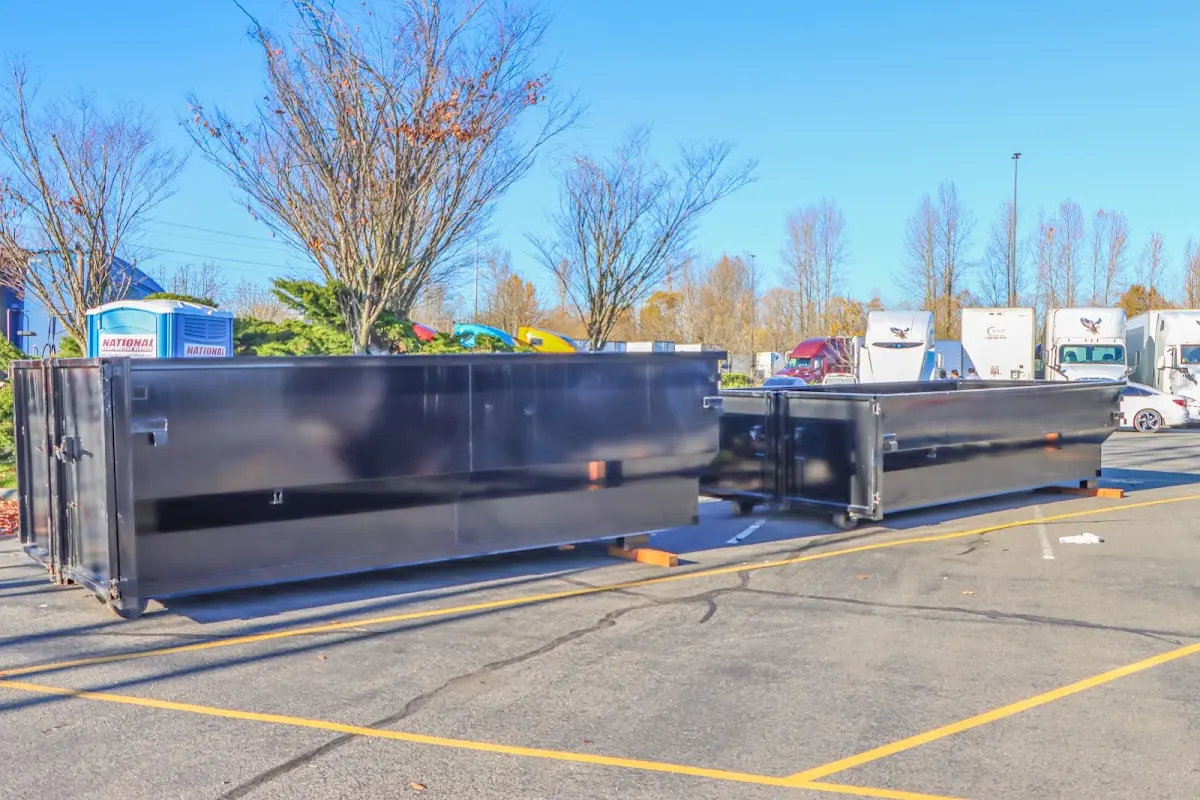 Professional dumpster rental service with roll-off container on residential driveway in Arlington Heights